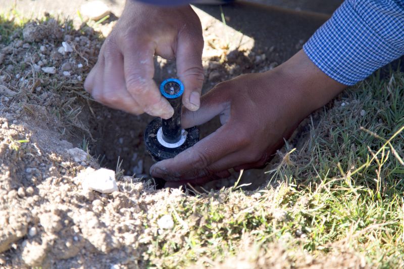 Technician Repairing Sprinkler Head